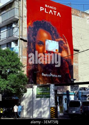 Large Banco Plata advertisement covers the side of a building in Roma Norte, Mexico City, reflecting fintech marketing, consumer finance & globalization Stock Photo