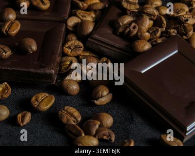 Coffee Beans and Dark Chocolate, dark chocolate and roasted coffee beans on black velvet background Stock Photo