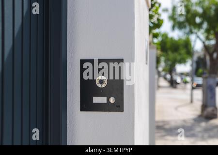 Modern video intercom system installed on residential building entrance wall, smart home access control technology with doorbell camera Stock Photo