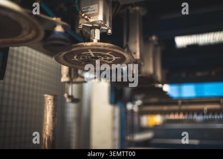 Close-up view of suction cups and pneumatic cylinders on a production line, highlighting precision engineering and automation Stock Photo