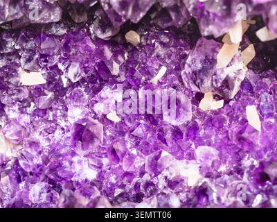 natural mineral background - rough amethyst crystals in geode close-up Stock Photo