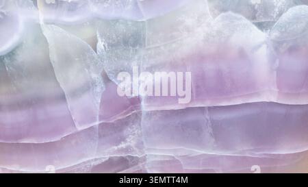 natural mineral panoramic background - surface of polished striped fluorite rock close-up Stock Photo