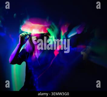 Person is wearing a VR helmet. Digital transformation and enjoying metaverse virtual world. Stock Photo