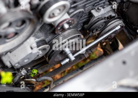 Timing belt route and rusted components in an engine bay. component wear, belt inspection, maintenance Stock Photo