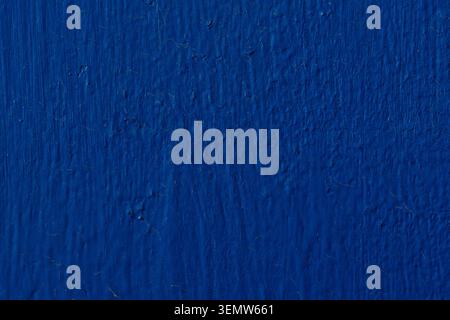Abstract dark blue painted wall texture background. Full frame of deep blue concrete or metal surface with brush strokes Stock Photo