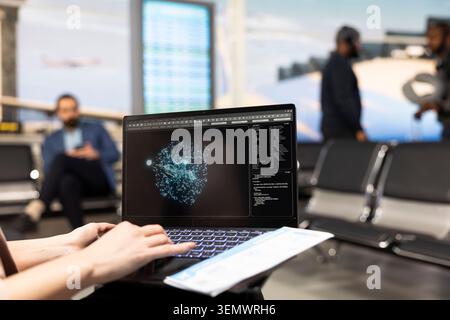 Artificial intelligence system, and cloud computing on laptop, delegate in airport lounge reviews big data automation with neural networks. Business trip concept with runway visible through window. Stock Photo