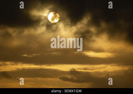 Sun bursts out from behind clouds, dramatic evening mood, North Sea, Denmark Stock Photo