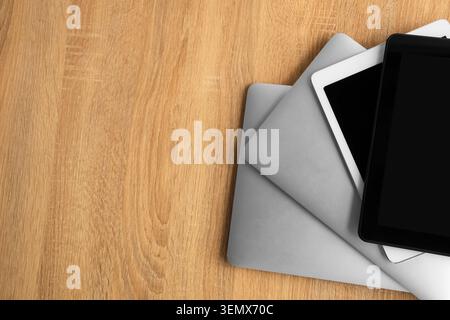 Stack of modern gadgets on wooden table Stock Photo