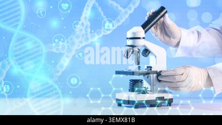 Medical research scientist using microscope for DNA analysis and genetic study in laboratory with digital overlays, digital overlays of DNA strands an Stock Photo