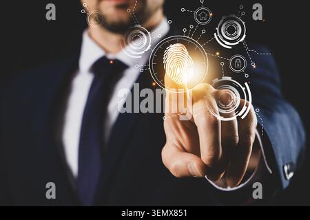 Biometric fingerprint security system for digital data protection and user authentication, business technology concept, a man in a suit interacts with Stock Photo