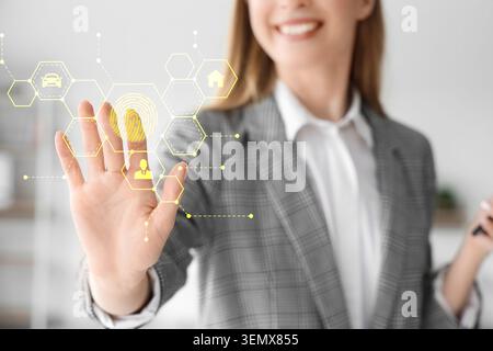 Biometric fingerprint security system for digital access and data protection, woman interacting with virtual interface, the technology provides secure Stock Photo