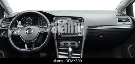 Modern car interior dashboard with steering wheel, infotainment system, and air vents on white background Stock Photo
