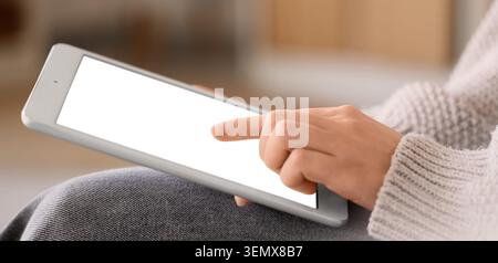 Person using digital tablet with blank white screen for online learning and business communication, the hand interacts with the touch screen, modern t Stock Photo