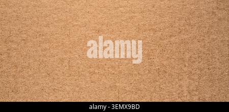 Natural brown hardboard texture background, recycled wood fiber material, sustainable packaging and craft surface Stock Photo