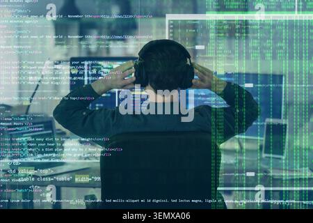 Software developer wearing headphones coding on computer screen with digital overlay programming and cybersecurity, this image cybersecurity data prot Stock Photo