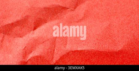 Vibrant red crumpled paper texture background with rough surface and abstract folds, creative design element, the close up view highlights the unique Stock Photo