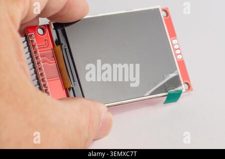 Close-up of an OLED display for microcontroller devices held in a hand. Stock Photo