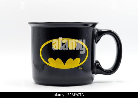 Black ceramic coffee mug with yellow batman superhero logo isolated on a white background. Stock Photo