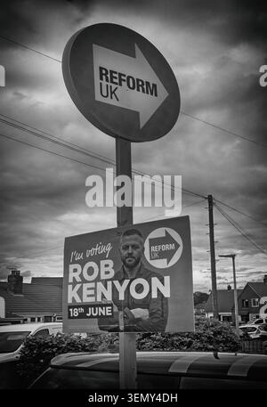 Reform UK by-election campaign sign and Rob Kenyon poster under storm clouds during the Makerfield by-election campaign, Wigan, June 2026. Stock Photo