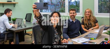 Banner of happy business team taking selfie at meeting in coworking office Stock Photo