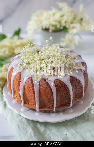 home made elderflower bundt cake with raspberries Stock Photo