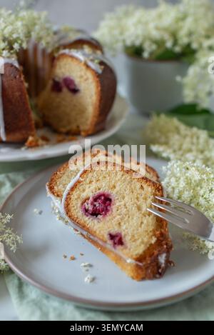 home made elderflower bundt cake with raspberries Stock Photo