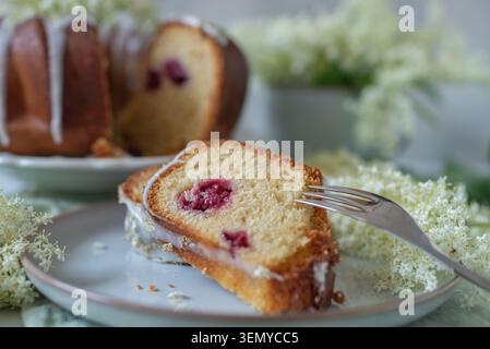 home made elderflower bundt cake with raspberries Stock Photo