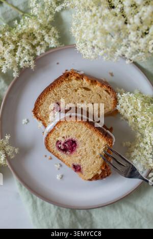 home made elderflower bundt cake with raspberries Stock Photo