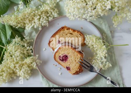home made elderflower bundt cake with raspberries Stock Photo