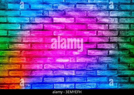 Abstract architectural background featuring an old brick wall surface illuminated with a colorful rainbow gradient of pink, purple, and blue neon ligh Stock Photo