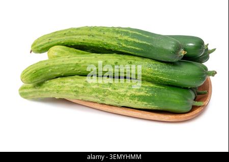 Pile of raw organic cucumbers in wooden plate Stock Photo