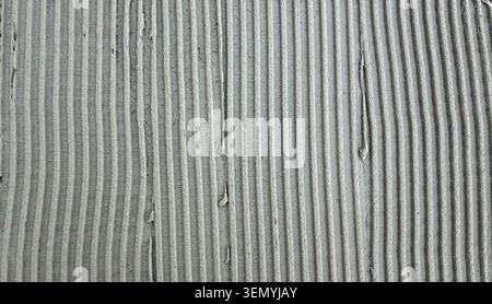 Textured gray cement surface with parallel grooves and ridges Stock Photo