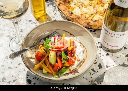 Delicious Summer Salad Paired With Wine and Pizza on a Sunny Afternoon Stock Photo