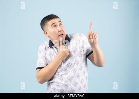 Handsome young expressive man posing emotionally in professional studio Stock Photo