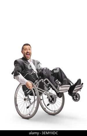 Crazy man in a ripped suit riding a wheelchair and laughing isolated on white background Stock Photo