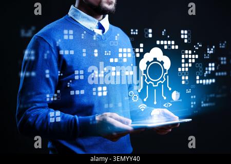 Man holds tablet and interacts with cloud and data graphics in digital space Stock Photo