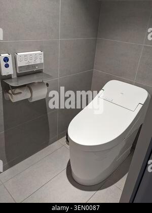 Modern Japanese smart bidet toilet with advanced control panel in a sleek tiled bathroom, Tokyo, Japan Stock Photo