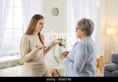 Frustrated adult woman complains her elderly wise mother about life problems Stock Photo