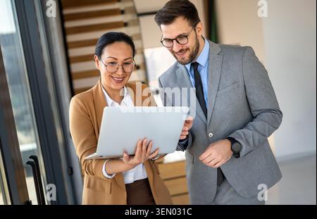 Mixed team of software engineers brainstorming ideas. Diverse app developers collaborating as group Stock Photo