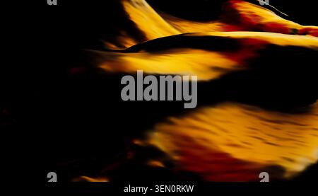 Abstract black and orange wave-like patterns with a fluid, dynamic feel. Stock Photo