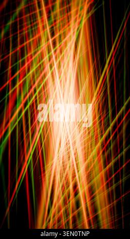 Bright intersecting red and green light trails creating a dynamic abstract pattern. Stock Photo