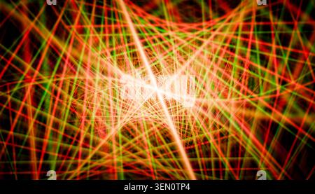 Abstract pattern of intersecting red and green light beams creating a geometric design. Stock Photo