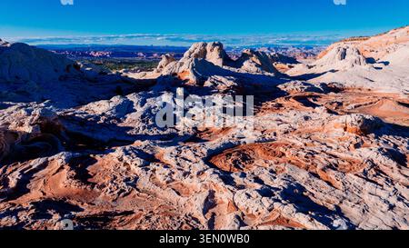 Vast desert landscape with red and white sandstone formations under a clear blue sky. Marble Canyon, Arizona, USA Stock Photo