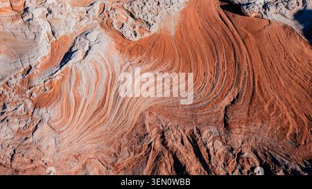 Aerial view of vibrant orange and white rock formations with striking wave patterns. Marble Canyon, Arizona, USA Stock Photo