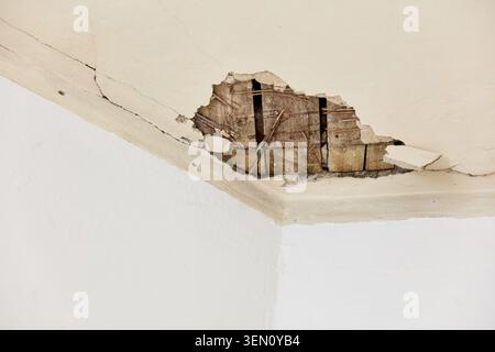 This captures significant ceiling damage and cracks in an old apartment located in Berlin, Prenzlauer Berg. Stock Photo