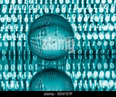 Transparent globe on reflective surface with binary code backdrop in teal hue. Stock Photo