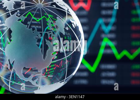 Transparent globe with stock market graphs in the background, featuring red and green lines. Stock Photo