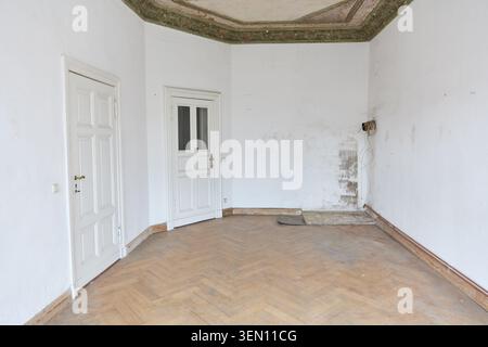 Empty apartment interior in an older building from around 1900 in Berlin, Prenzlauer Berg district, showcasing the space before renovation. The room f Stock Photo