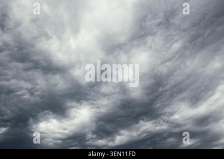 overcast sky background photo. Dramatic gray clouds in the storm sky. Stock Photo