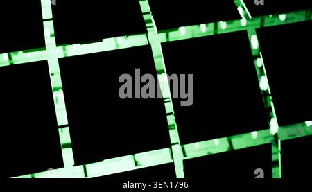 Abstract pattern of green illuminated grid against a dark background. Stock Photo